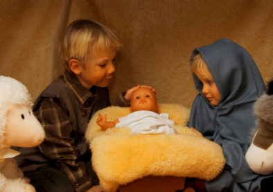 Realistic baby doll used in nativity scene display with children