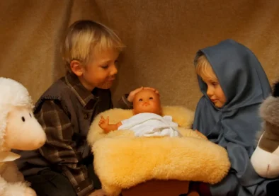 Realistic baby doll used in nativity scene display with children