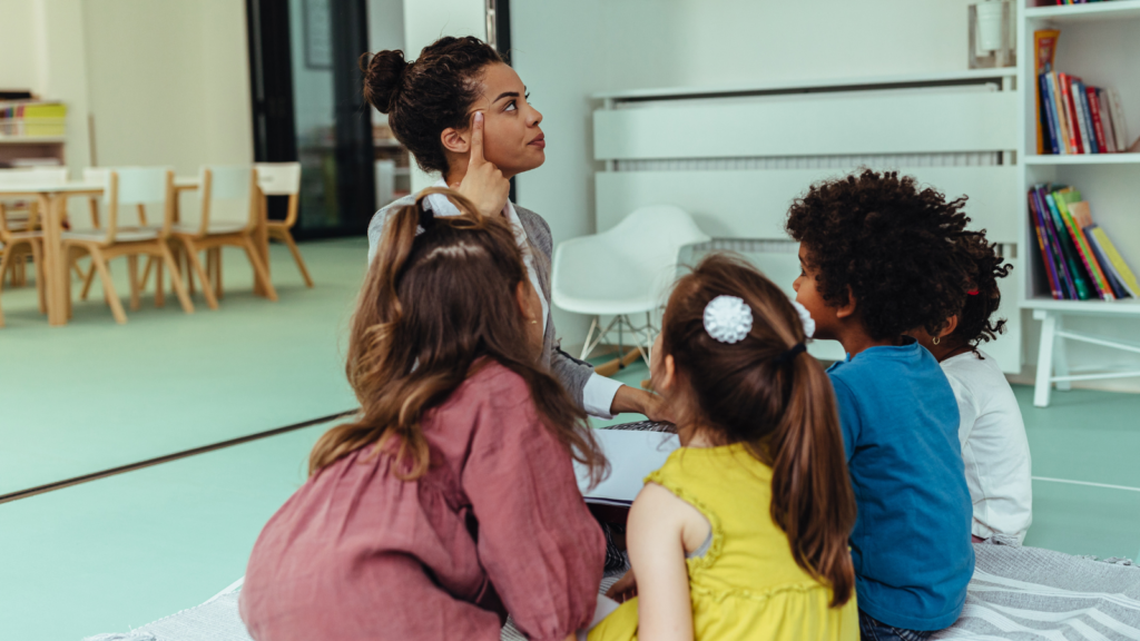 Teacher demonstrating with realistic infant doll in classroom setting