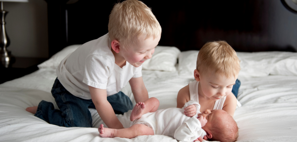 Sibling preparation doll used in a calm family setting before welcoming a new baby