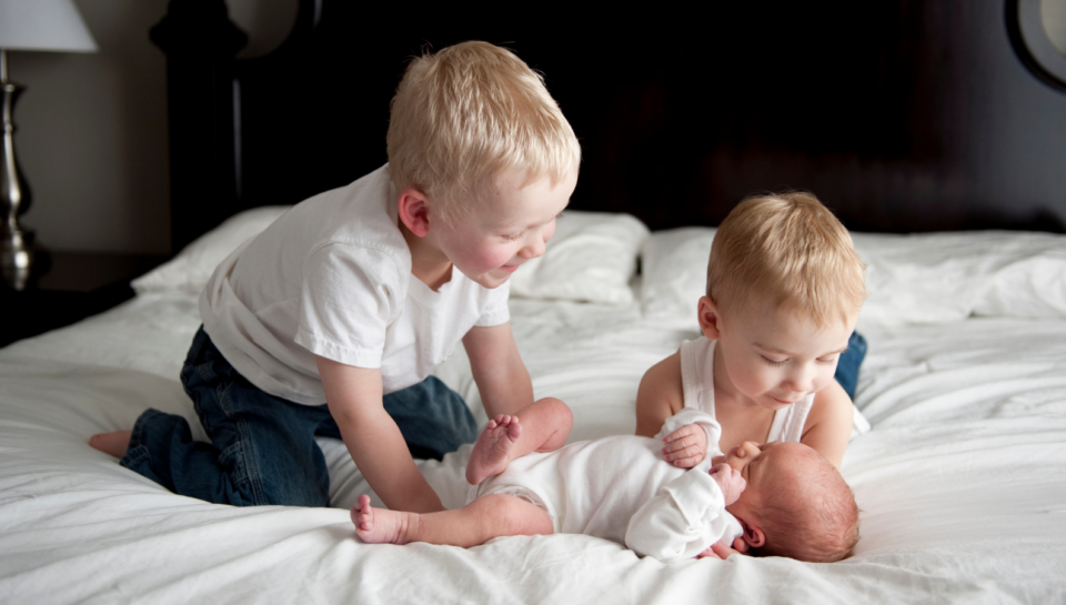 Sibling preparation doll used in a calm family setting before welcoming a new baby