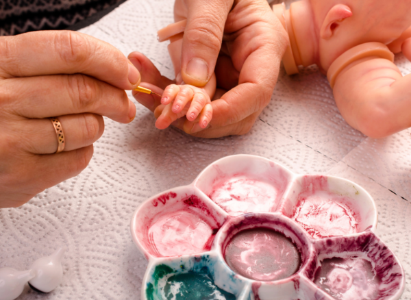 Vinyl Reborn Doll Hand Painting Detail | Nurtura Australia Vinyl reborn doll being hand painted with fine detail brush, showing realistic skin tone and craftsmanship