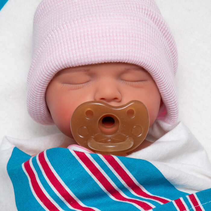 Sweet Snuggles girl full body silicone reborn doll wrapped in hospital blanket with dummy and beanie
